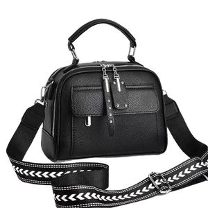 Classic black pebble leather crossbody bag with stylish wide geometric woven shoulder strap