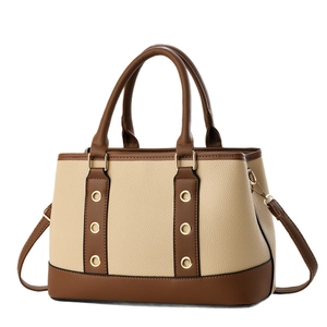 Beige and brown two-tone handbag with lychee texture and adjustable shoulder strap