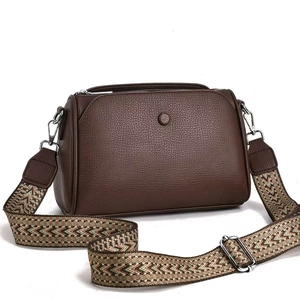 Brown lychee leather crossbody bag with wide ethnic style woven strap and silver hardware