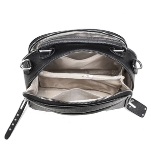 Top view of black pebbled leather handbag showing three internal compartments and silver zip