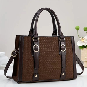 Deep brown tote bag featuring woven texture and smooth leather finish with gold hardware