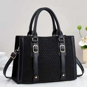 Chic black tote bag with woven texture, golden buckle details and detachable strap