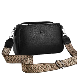 Classic black pebble leather crossbody bag with a vintage patterned wide shoulder strap