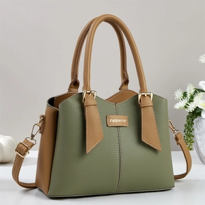 Macro detail of leather stitching and fashion buckle on green and brown handbag