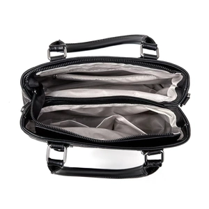 Top view of large black handbag interior with multiple compartments and herringbone lining