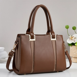 Deep brown minimalist tote bag with woven leather texture and golden metal hardware