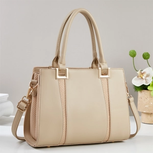 Elegant beige structured tote bag with woven side panels and gold hardware accents