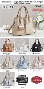 Detail view of large tote bag with textured surface and metallic tassel in multiple colors