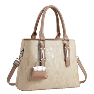 Elegant apricot striped faux leather tote bag with crossbody strap and mini bag charm