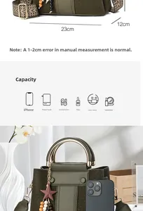 Detail of dark green bucket bag with metal ring handle and size labels showing 23cm length