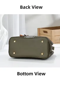 Detailed bottom view of olive green leather handbag showing four gold protective feet