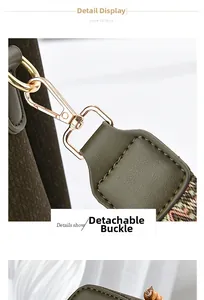 Detail of green leather handbag with detachable gold clasp and woven shoulder strap