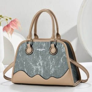 Elegant contrast leather and striped fabric handbag with adjustable shoulder strap