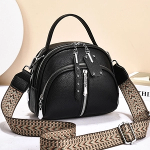 Elegant black lychee texture crossbody bag with silver zippers and wide woven strap