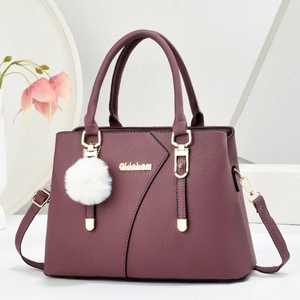 Deep purple pebbled leather handbag with gold hardware and white faux fur pompom charm