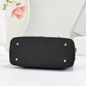 Close-up of black lychee grain leather handbag base with four protective gold metal studs