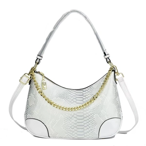 White snakeskin embossed hobo bag with a chunky gold chain and adjustable shoulder strap