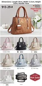 Detailed view of large capacity PU handbag with multi-layer interior and mini bag charm