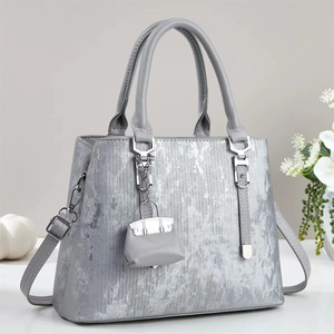 Chic silver grey vertical striped tote bag with top handles and adjustable shoulder strap