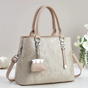 Elegant textured tote bag with top handle and micro handbag charm for women