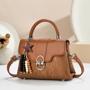 Caramel brown leather and corduroy handbag with star pendant and silver ring closure