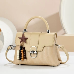 Minimalist beige handbag with silver lock and star charm on geometric background