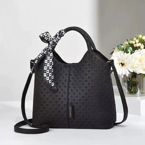 Elegant black woven bucket bag with silk scarf handle and adjustable crossbody strap
