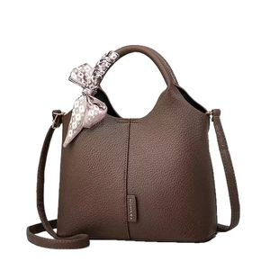 Brown lychee leather bucket bag with top handle and silk scarf detail for women