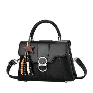 Elegant black handbag with star bead charm and silver clasp on white background