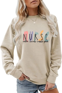 Detail of Nurse Coffee Scrubs print on a tan crewneck sweatshirt with colorful accents
