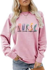 Detail of pink crewneck sweatshirt with Nurse Coffee Scrubs colorful typography print