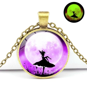 Glow-in-the-dark butterfly fairy pendant showing green fluorescence in dark