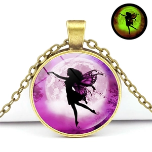 Detailed view of bronze fairy pendant with glowing green butterfly effect in the dark