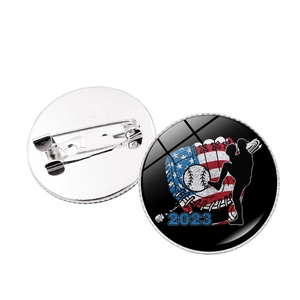 Detailed view of round 2023 baseball badge featuring USA flag motif and safety pin back