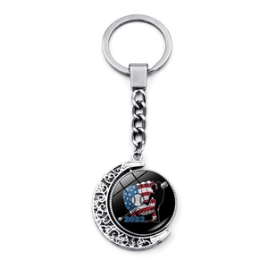 Detail of a 2023 rotating baseball keychain with US flag pattern and metal filigree