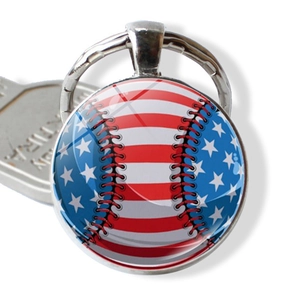 Detail of USA flag baseball pendant keychain with silver metal frame and glass dome texture