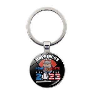 Detail of baseball keychain with cartoon bear and Happiness Is On Home Plate text