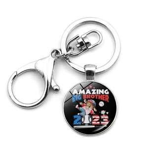 Detail of silver baseball keychain featuring Amazing Big Brother 2023 dog pendant