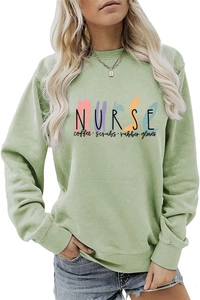 Detail shot of the Nurse Coffee Scrubs lettering on a light green crewneck sweatshirt