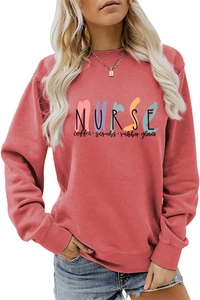 Close-up of Nurse Coffee Scrubs print on brick red crewneck sweatshirt fabric