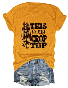 Flat lay of yellow crop top with corn print and blue distressed denim shorts