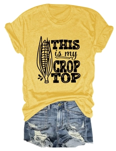 Detailed flat lay of a yellow graphic crop top with corn print and blue denim shorts