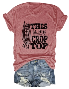 Flat lay of maroon crop top with humor corn print and frayed denim shorts set