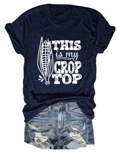 Detailed flat lay of navy crop top with corn print and distressed denim shorts set