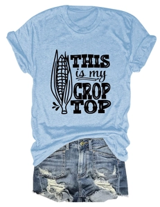 Flat lay of light blue cotton T-shirt with 'This is my Crop Top' print and denim shorts