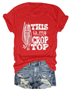 Flat lay of red cotton crop top with graphic print and distressed denim shorts
