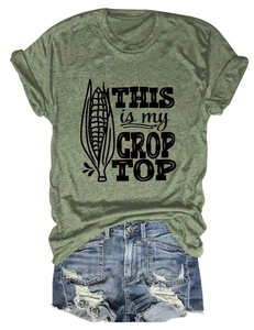 Flat lay of army green crop top with corn graphic and distressed blue denim shorts
