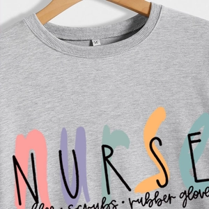 Gray nurse coffee scrubs print sweatshirt with crew neck on wooden hanger display