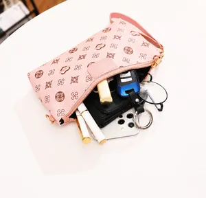 Internal view of pink crossbody bag holding phone, glasses, lipstick and wallet