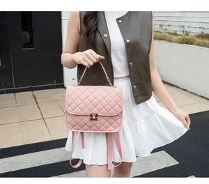 Detailed view of pink quilted PU leather backpack featuring a golden metal lock